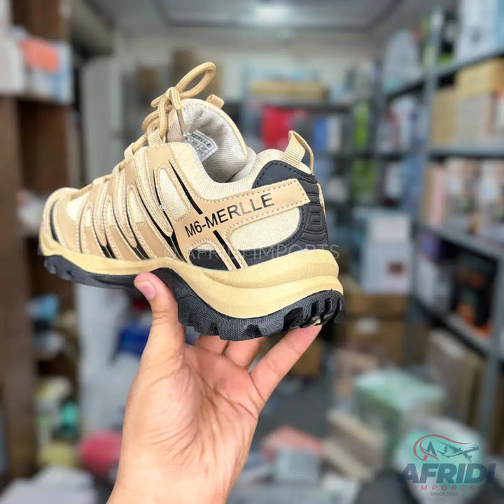 A tan and black athletic shoe with a thick sole and textured grip.