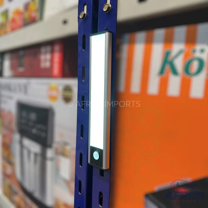 Silver rectangular LED light strip with a round button at the bottom.