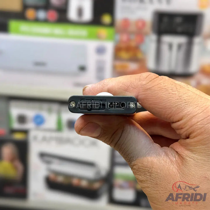 A black miniature device with a switch, a small button, and two ports.