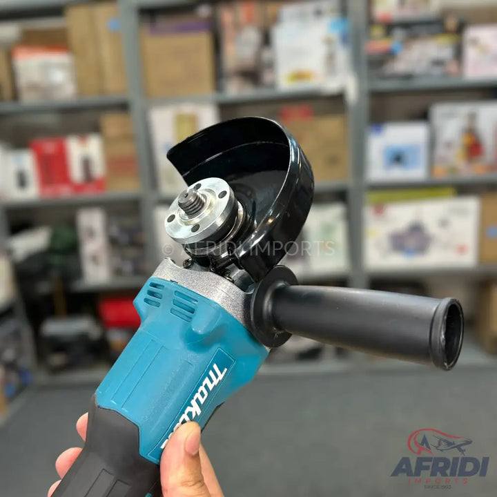 A light blue and black angle grinder with a black safety guard, a silver spindle, and a black auxiliary handle.