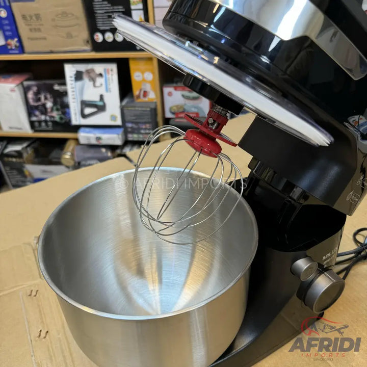 Black stand mixer with a stainless steel bowl and a wire whisk attachment.