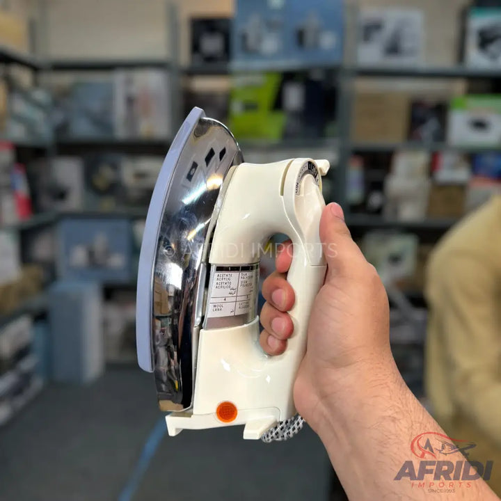 A white and chrome electric steam iron with a textured grip.
