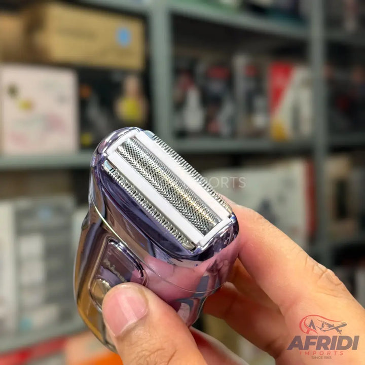 A purple and silver electric shaver with a dual-foil head.