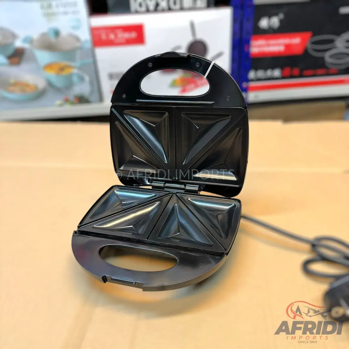 Black electric sandwich maker with non-stick triangular cooking plates.