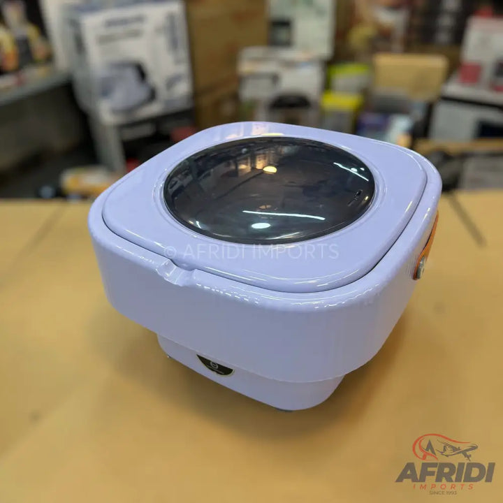 Compact, portable ultrasonic washing machine with a clear top lid.