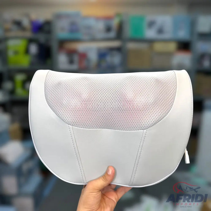 White U-shaped massage pillow with a mesh center and visible massage nodes.