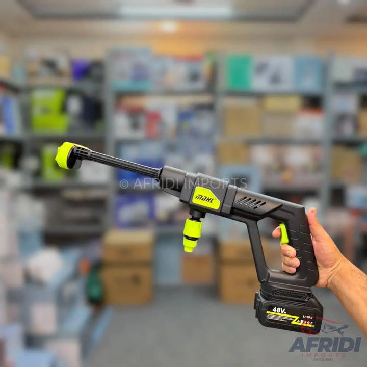 A handheld, cordless electric pressure washer with a long nozzle and a removable battery pack.