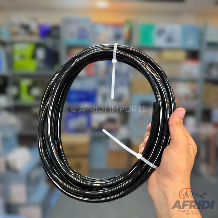 Black coiled flexible hose secured with white cable ties.