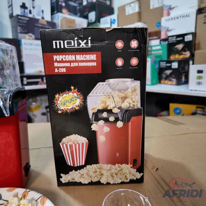 Red and black popcorn machine in its packaging.