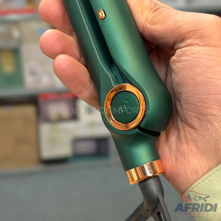 A dark green hair straightener with rose gold accents.