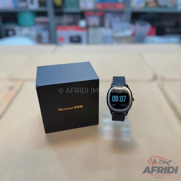 A black smartwatch with a round display and a matching black strap, accompanied by its square packaging box.