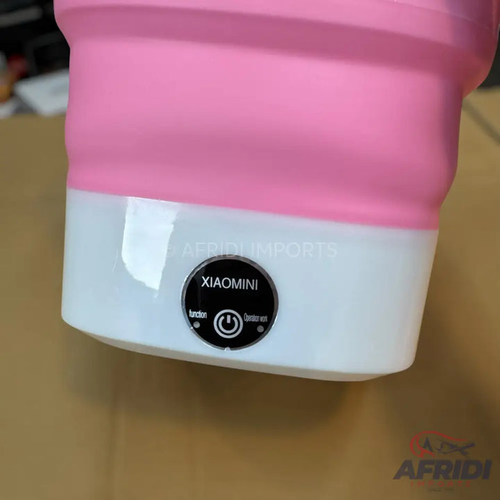Pink and white collapsible portable washing machine