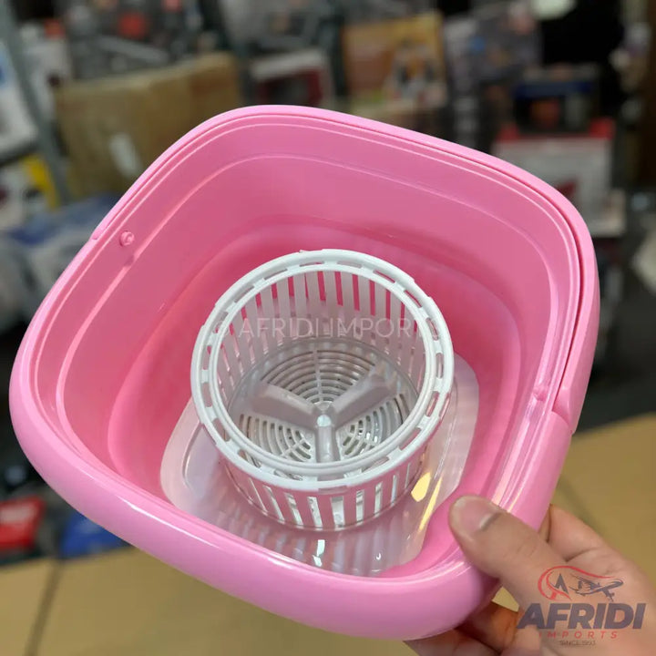 Pink collapsible bucket with an integrated spin mop wringer.