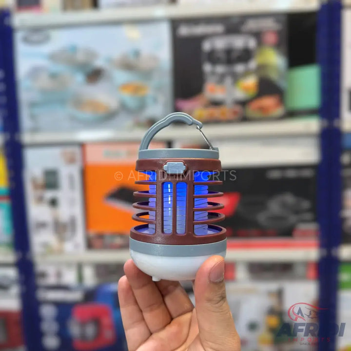 A portable, rechargeable mosquito killer lamp with a blue UV light and a hanging hook.
