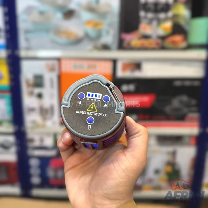 Handheld device with electric shock warning and battery indicator.