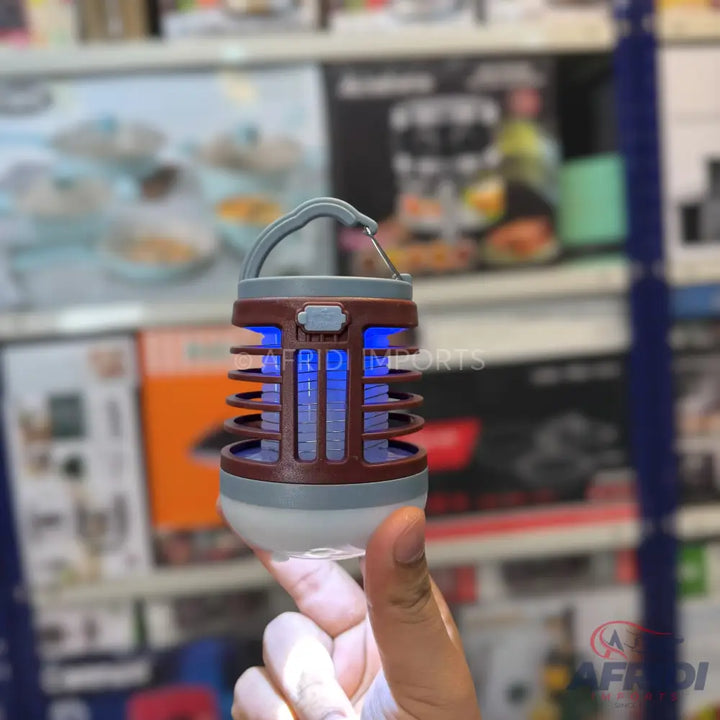 A portable, compact insect zapper with a blue light and a hanging hook, also functioning as a lantern.