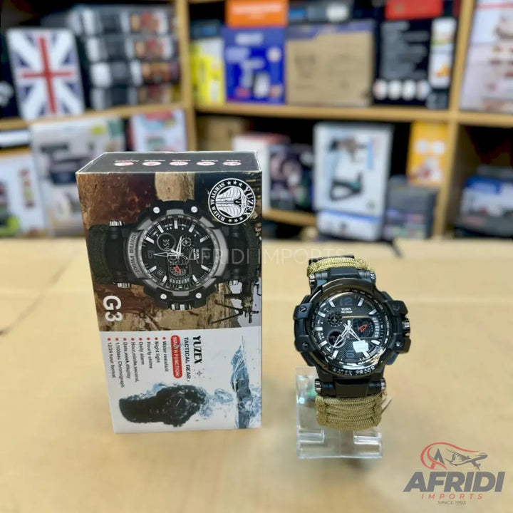 Black analog-digital wristwatch with a camouflage-patterned band and a matching box.