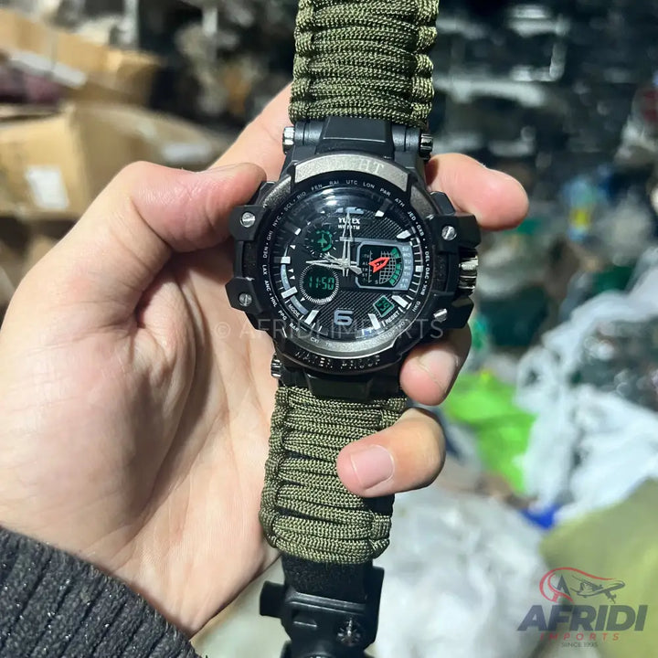 Black tactical watch with a green paracord strap.