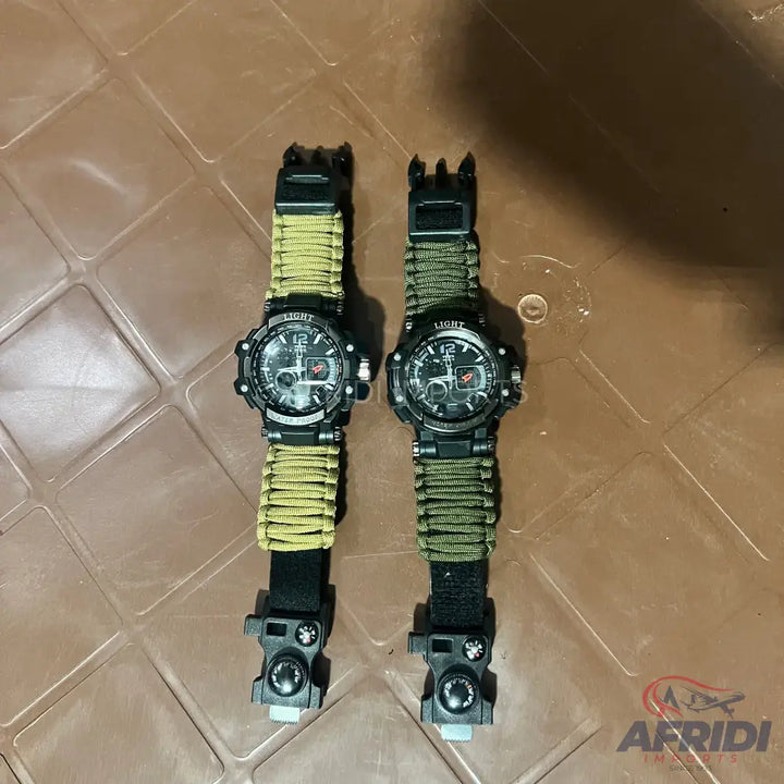 Two black tactical watches with olive green paracord straps and multi-tool buckles.