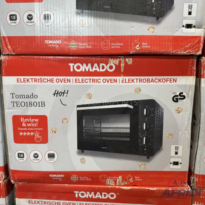 Black electric oven in packaging with specifications.