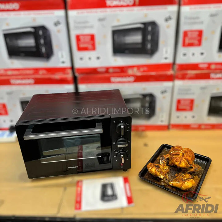 Black countertop toaster oven with a clear glass door and three control knobs.