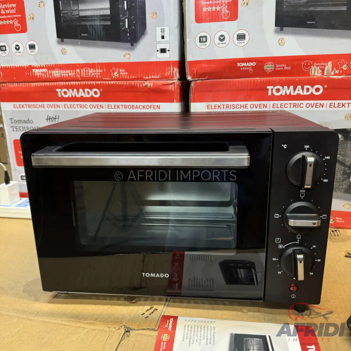 Black electric oven with a glass door and three control knobs.