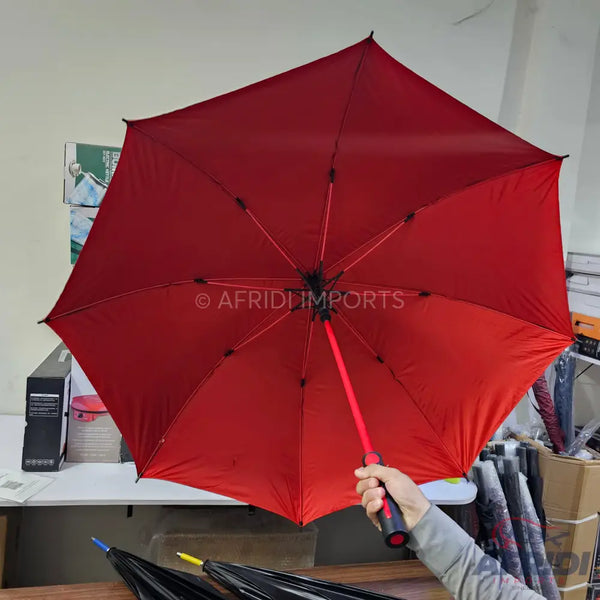 Red umbrella with a black and red handle.