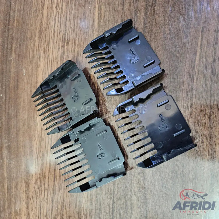 Four black plastic hair clipper guide combs of various lengths.