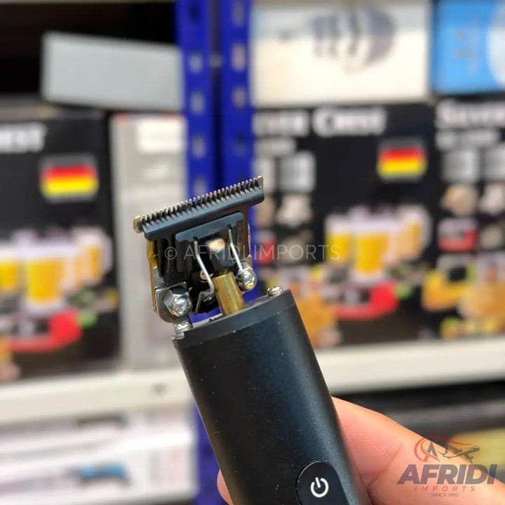 A black electric hair trimmer with a visible blade.
