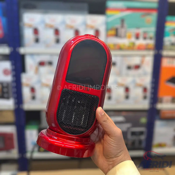Glossy red, portable electric heater with a black display screen and a black mesh grille.