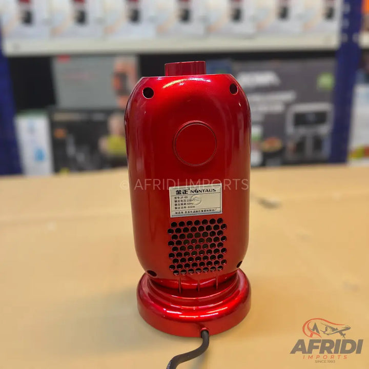 Glossy red electric coffee roaster with a perforated base.