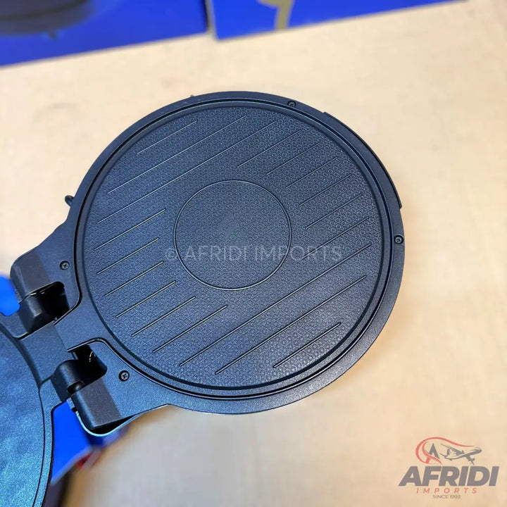 Dark blue, round, textured waffle maker plate.