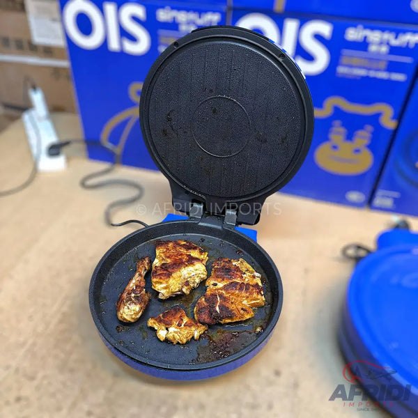 Blue electric griddle with cooked chicken pieces