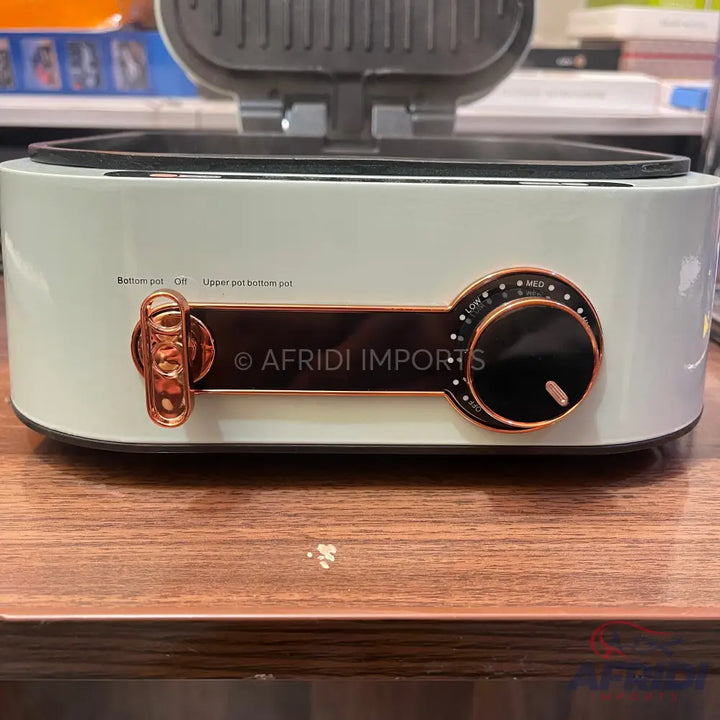 White and copper-toned electric griddle with temperature control.