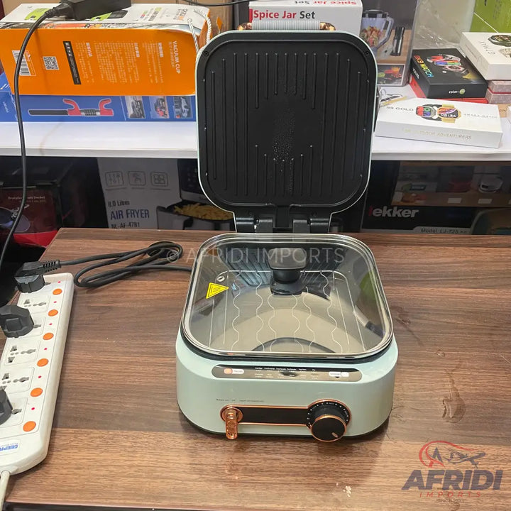 Light green electric griddle with an open top grill and a glass-lidded cooking pot.