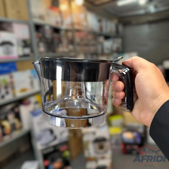 Clear plastic measuring jug with a black handle and lid.