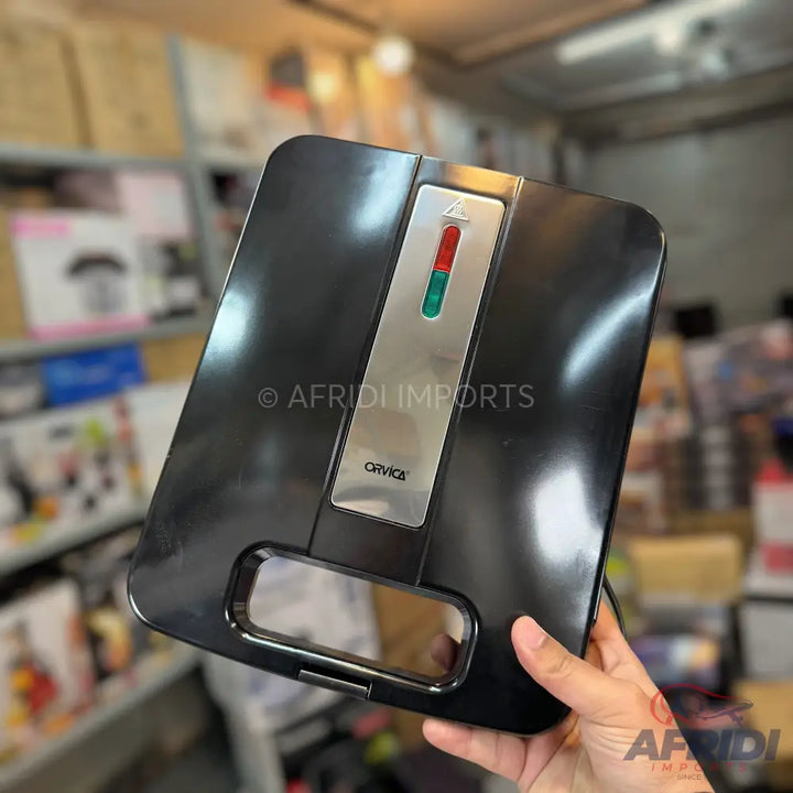 Black electric sandwich maker with indicator lights.