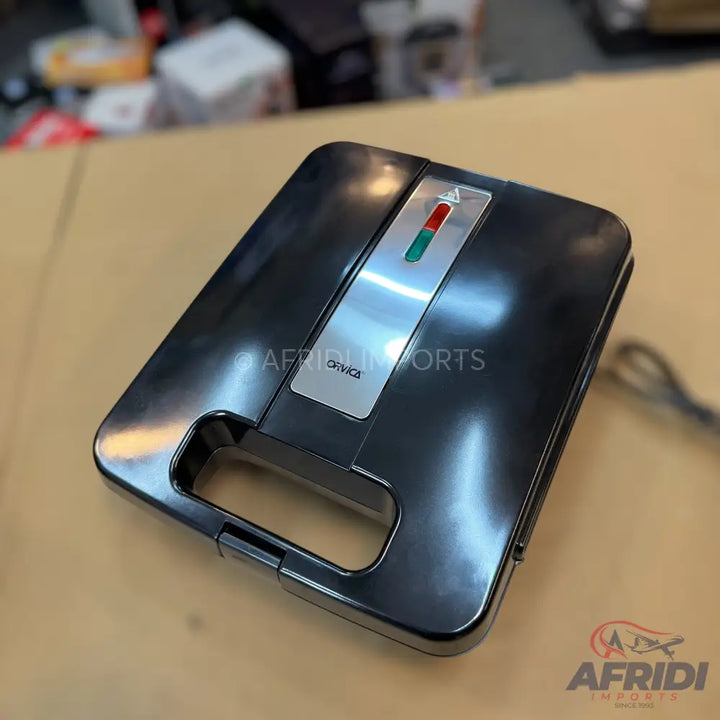 Dark grey electric sandwich maker with red and green indicator lights.