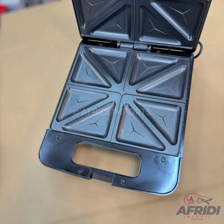 Open electric sandwich maker with eight triangular compartments.