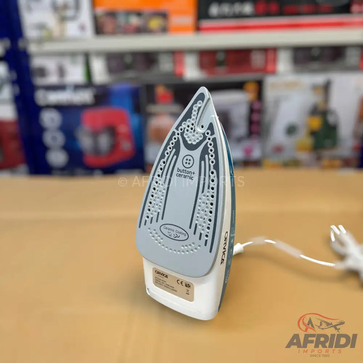 White and blue ceramic steam iron with a pointed soleplate.