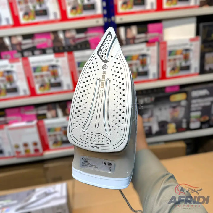 A ceramic-soled steam iron with a perforated soleplate.