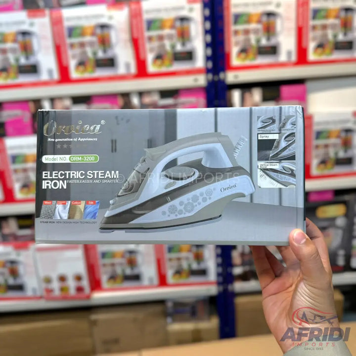 Boxed electric steam iron with a grey and white design.