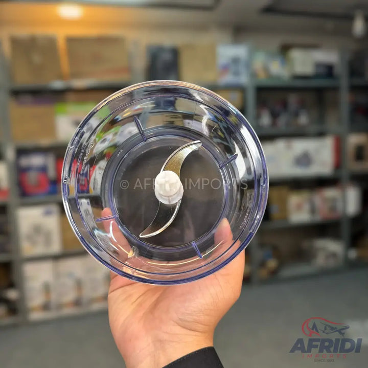 A clear plastic blender cup with a two-pronged blade.