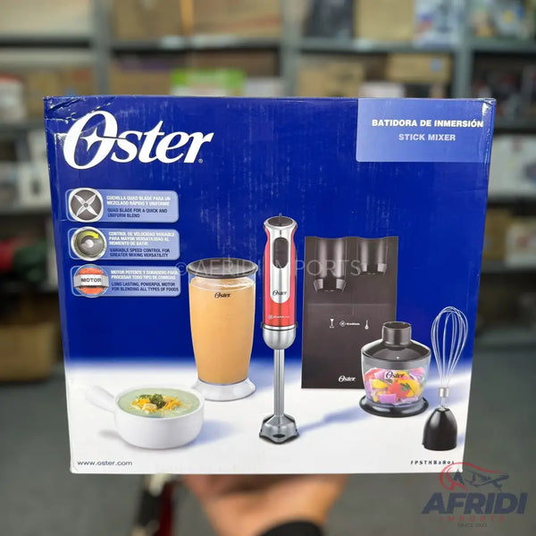 An Oster immersion blender (stick mixer) with multiple attachments, including a whisk, chopper, and mixing cups, for blending, whipping, and chopping food items.