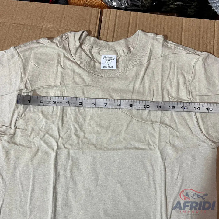 A light-colored short-sleeved t-shirt with a measuring tape across its chest.