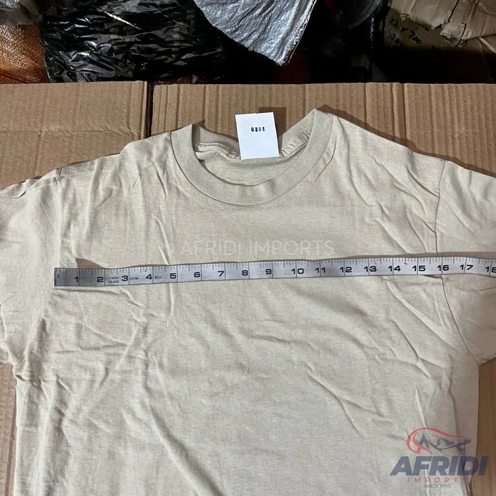 A light-colored, short-sleeved t-shirt with a measuring tape laid across the chest.