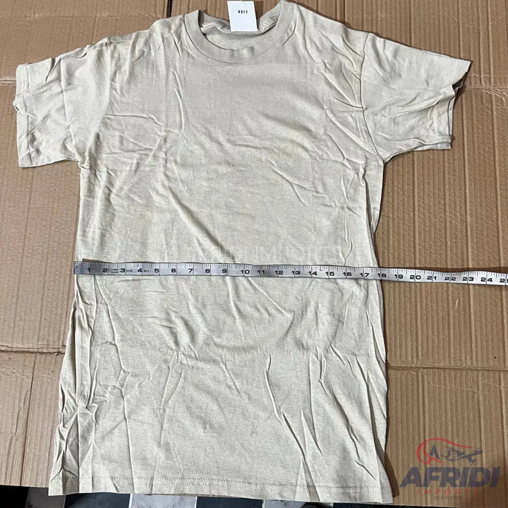 A light-colored, short-sleeved t-shirt with a measuring tape laid across it.