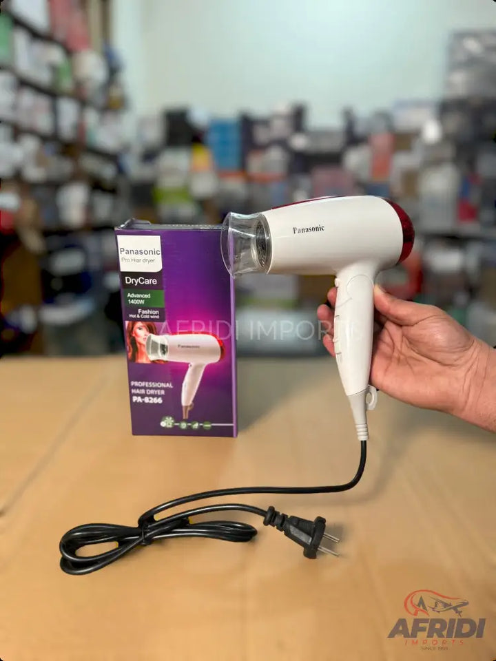 White and red hair dryer with a narrow nozzle and a black power cord.