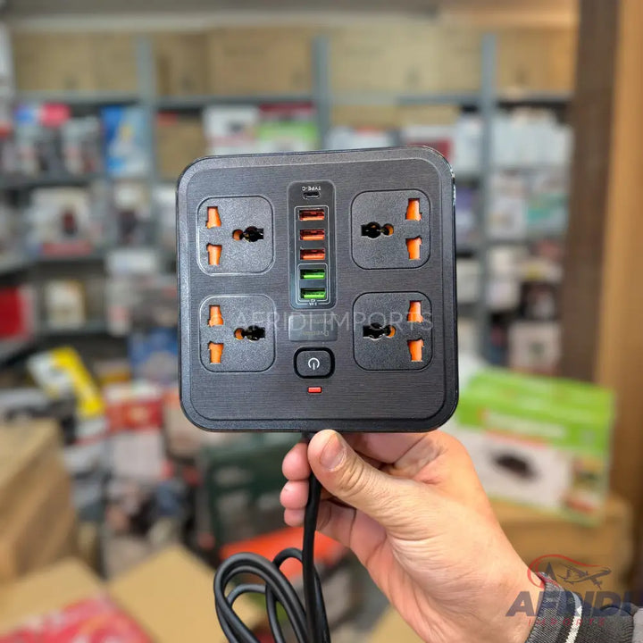 Black square power strip with four universal outlets and four USB ports.