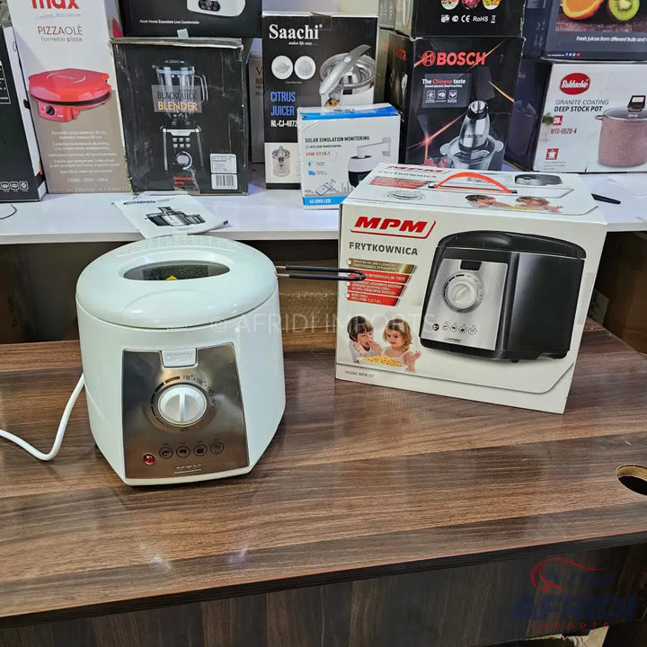 White electric deep fryer with a silver control panel and black accents.